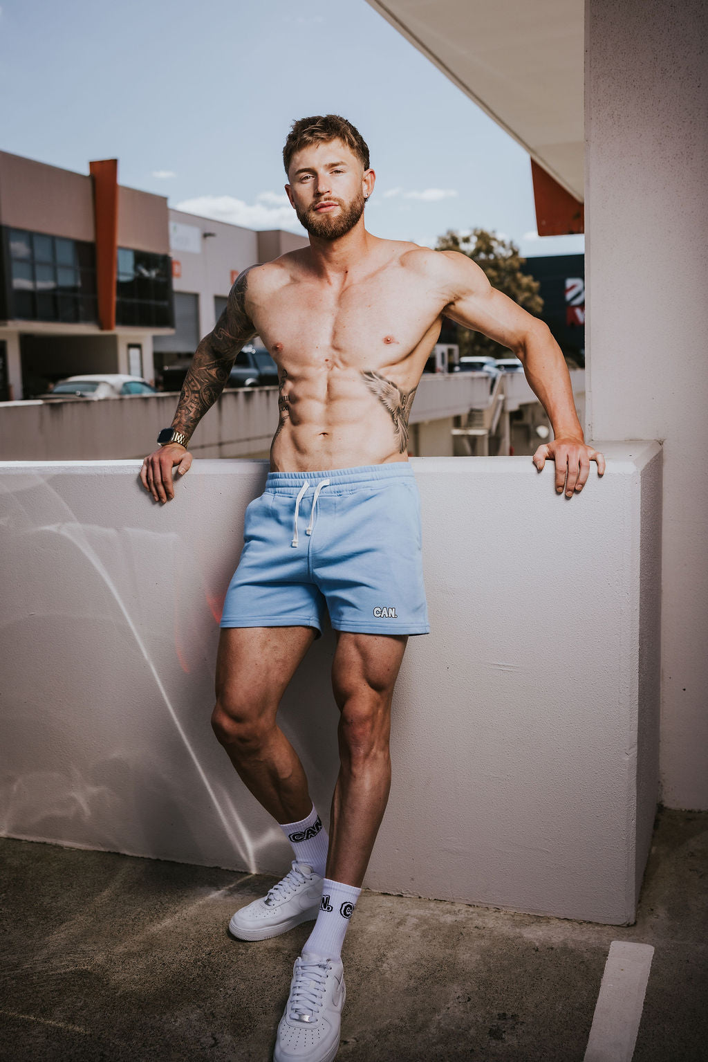 Man wearing CAN. Syndicate blue Can. Syndicate Active shorts and Crew Socks